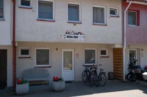 a building with bikes parked in front of it at Nida Inn Self Check-in in Nida