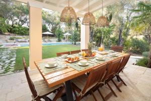 a dining room with a table and chairs at Apelia Estate - Among Ancient Olives, Experience the Quiet Soul of Corfu in Corfu