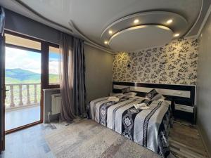 a bedroom with a bed and a large window at AVAGYAN'S Hotel-restaurant in Goris +133 photos