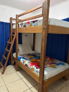 two bunk beds in a room with a ladder at Mapi's House in Paquera +37 photos