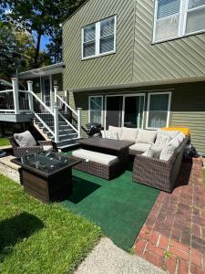 a patio with couches and a table on a lawn at Matt Cozy Quarters in Orangeburg
