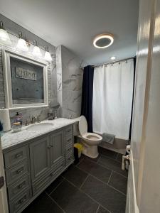 a bathroom with a sink and a toilet and a tub at Matt Cozy Quarters in Orangeburg +7 photos
