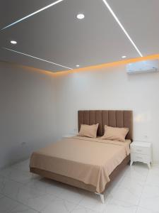 a bedroom with a bed in a white room at Villa VIP in Midoun