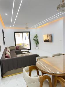 a living room with a couch and a table at Villa VIP in Midoun
