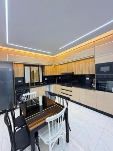 a kitchen with a table and chairs in a room at Villa VIP in Midoun