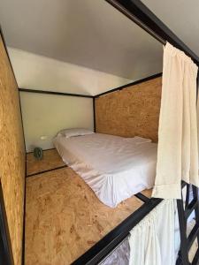 a small bedroom with a bed in the middle at Solarte Hostel in Vergara