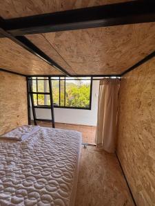 a bed in a room with a window at Solarte Hostel in Vergara