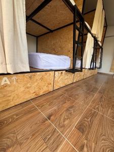 a room with a bunk bed and a wooden floor at Solarte Hostel in Vergara