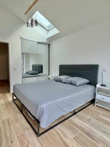 a bedroom with a large bed and a mirror at Bed & Breakfast L'Etape Basque in Bidart +23 photos