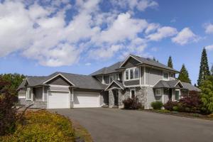 a large house with a driveway at Naturally Pacific Resort in Campbell River