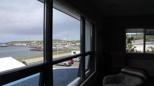 a room with a window looking out at a parking lot at Guesthouse Maddy in Húsavík