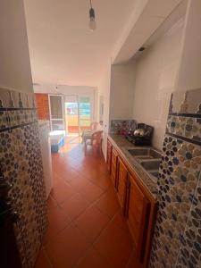 a kitchen with a sink and a counter top at Residence Jamal Only Family in Martil