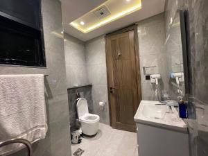 a bathroom with a toilet and a sink at Designer Boutique Hotel Serviced Apartments Bahria Town Islamabad & Rawalpindi - LMY in Rawalpindi