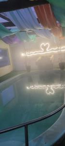 a swimming pool in a house with a ceiling at Hotel Mirage Spa in Carhué +7 photos