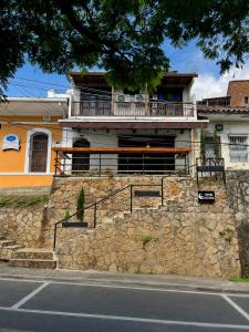 a house on top of a stone wall at Hotel Altana in Cali