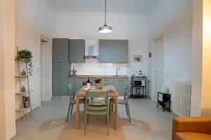 a kitchen with a table and chairs in a room at Dimora Noè e Concettina in Botrugno