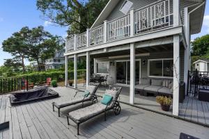 a porch with two chairs and a porch swing at Waterfront Cottage w Pool Beach Access in Fort Erie