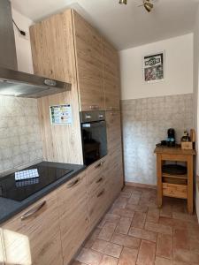 a kitchen with wooden cabinets and a counter top at Corte Magnolia Terme & Lago di Garda in Colà di Lazise +12 photos