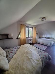 a bedroom with two beds and a window at Przystanek Kaszuby in Kamień
