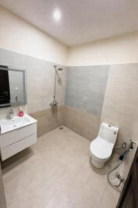 a bathroom with a toilet and a sink at Second Stay apartments in Faisalabad