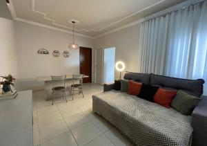 a living room with a couch and a table at Dali Apart hotel in Ipatinga