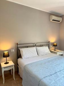 a bedroom with a large bed with two night stands at Corte Magnolia Terme & Lago di Garda in Colà di Lazise