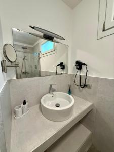 a bathroom with a sink and a mirror at Corte Magnolia Terme & Lago di Garda in Colà di Lazise