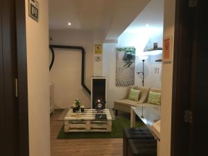 a living room with a couch and a table at Pensión Residencia Fonseca in Santiago de Compostela