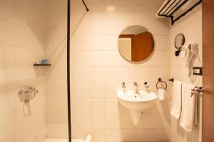 a bathroom with a sink and a shower at Riwaq Pyramids View Inn & Rooftop in Cairo