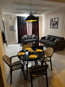 a living room with a black table and chairs at Second Stay apartments in Faisalabad