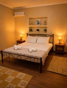 a bedroom with a large bed with two night stands at Pipitsa's House-Votsalakia Beach in Votsalákia +3 photos