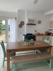 a kitchen with a wooden table and chairs in a kitchen at Shiri Beach Resort in Zanzibar City