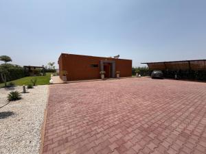 a brick driveway in front of a building at Villa 74 Serenety in Heddad