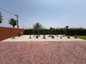 a brick driveway with trees and plants in it at Villa 74 Serenety in Heddad