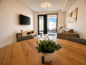 a living room with a wooden table and a couch at House Vista Azul in Puerto Madryn