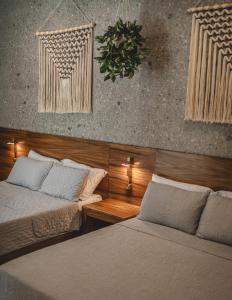 a bedroom with two beds and a wall at Suite Premium con piscina privada en Valladolid - Penca Leonor 12 in Valladolid