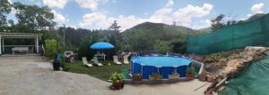 a backyard with a swimming pool and a fire hydrant at Vila Milka in Lepterija
