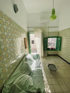 a hospital room with a large bed in the corner at Dar El Mdina in Mahdia
