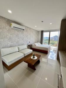 a living room with a couch and a bed and a table at Ola del Mar in Gaira +61 photos