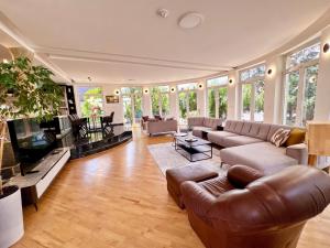 a living room with a couch and a television at Royal Sun Villa in Sarajevo
