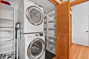 a laundry room with a washer and dryer at Redwood Oasis - Luxe Santa Cruz Cabin w/ Hot Tub in Ben Lomond