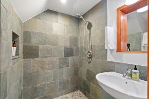a bathroom with a sink and a shower at Redwood Oasis - Luxe Santa Cruz Cabin w/ Hot Tub in Ben Lomond +22 photos
