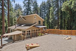 a house in the woods with a playground at Redwood Oasis - Luxe Santa Cruz Cabin w/ Hot Tub in Ben Lomond