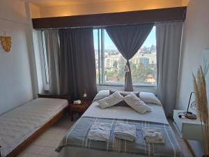 a bedroom with a bed and a large window at Bariloche del Sur in San Carlos de Bariloche