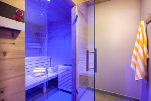 a bathroom with a shower and a glass door at Postresidenz in Mayrhofen