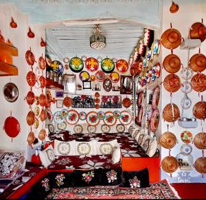a living room filled with lots of plates on a wall at Cultural guest house in Hārer