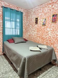 a bedroom with a bed in a room with wallpaper at Cristales de Antigua La Calzada in Antigua Guatemala