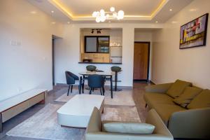 a living room with a couch and a table at Kiara Apartments in Kigali +8 photos