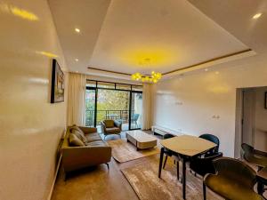 a living room with a couch and a table at Kiara Apartments in Kigali