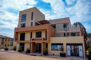 a large building with windows on top of it at Kiara Apartments in Kigali